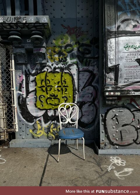 A chair in the middle of the Manhattan bridge