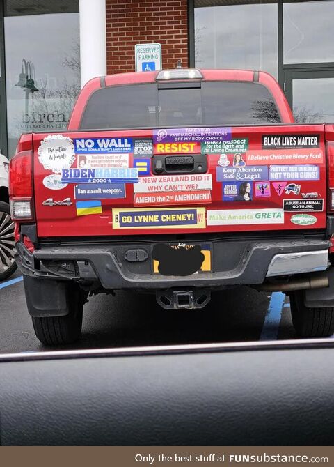 A red truck with stickers on the back