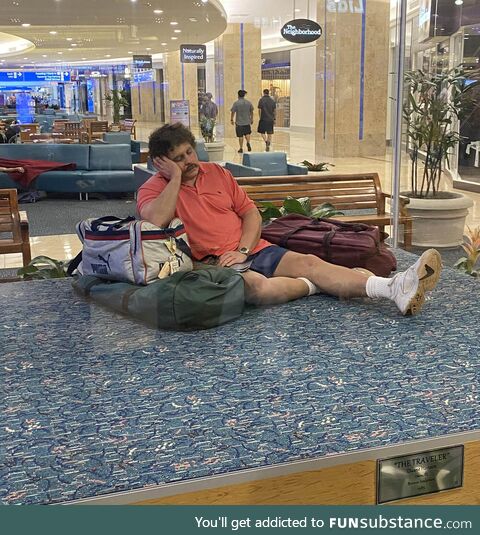 This is not a middle-aged guy tired from traveling - it's a bronze sculpture in an