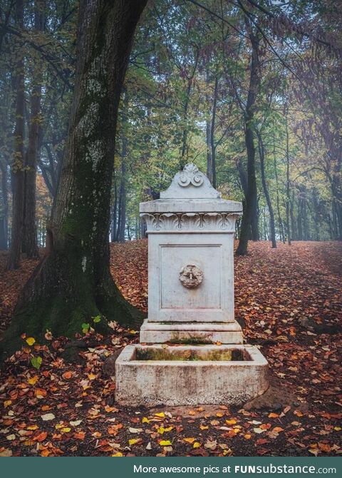 The old marble fountain in the forest on Oplenac hill in Serbia