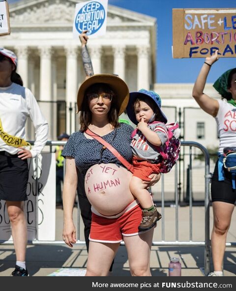 Pregnant woman protesting against supreme court decision about Roe v. Wade