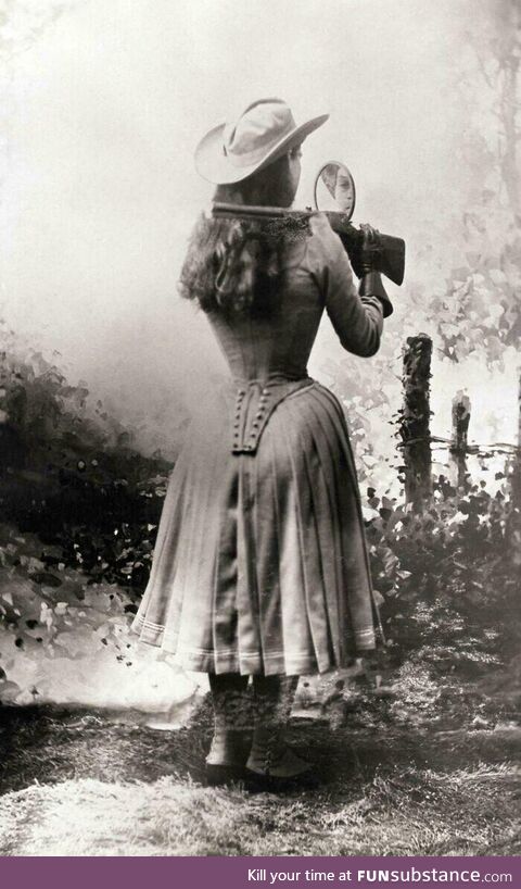 Sharpshooter Annie Oakley shooting over her shoulder using a hand mirror 1899