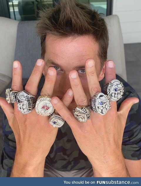 Tom Brady wearing his 7 Super Bowl Rings
