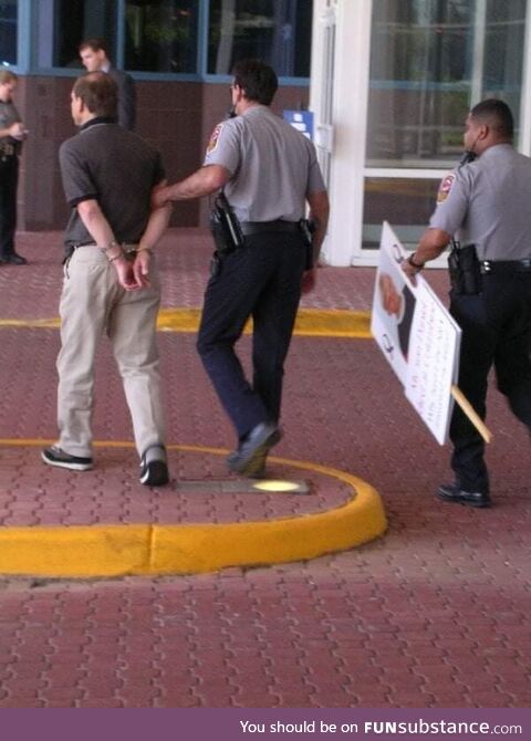 Columbine father Tom Mauser being arrested for protesting the NRA wearing his deceased