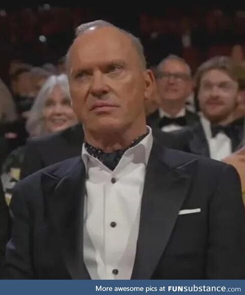 Michael Keaton at 2024 Oscars watches presentation by Danny DeVito and Arnold