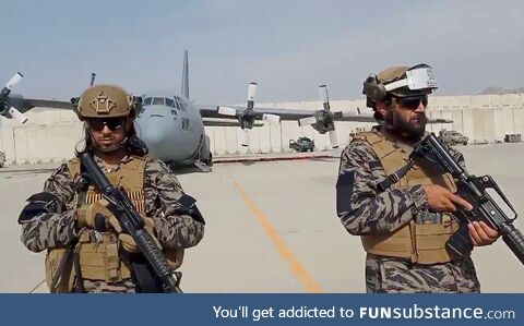 Taliban fighters from the 313 Badri division guard Kabul airport after final withdrawal