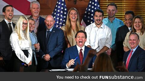 Ron DeSantis laughs after signing the bill removing funding for equity programs in