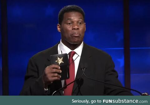 Herschel Walker flashes a fake badge during the Georgia senate debate