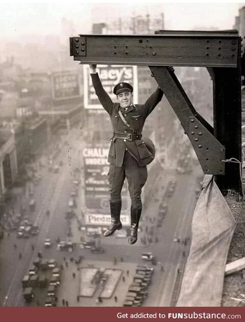 A New York policeman hanging from a girder, 1920